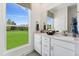 Bright bathroom with double vanity, modern fixtures, and a large window overlooking a lush, green landscape at 2808 Kempthorne Rd # 61, Cary, NC 27519