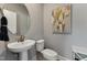Neat powder room featuring a pedestal sink, round mirror, minimalist artwork, and neutral wall color at 2808 Kempthorne Rd # 61, Cary, NC 27519