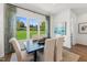 Elegant dining room with a dark wood table, seating for six, and a large window with outdoor views at 2808 Kempthorne Rd # 61, Cary, NC 27519