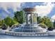 View of the Frantz Square water fountain featuring a tiered design, stone accents, and landscaping at 2808 Kempthorne Rd # 61, Cary, NC 27519