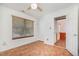 Well-lit bedroom with hardwood floors, a ceiling fan, and access to the hallway at 2817 Henslowe Dr, Raleigh, NC 27603