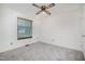 This bedroom has neutral carpeting, a ceiling fan and a window at 2817 Henslowe Dr, Raleigh, NC 27603