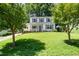 Charming two-story home featuring a well-manicured front lawn and classic white exterior with black shutters at 2817 Henslowe Dr, Raleigh, NC 27603