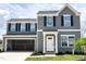 Two-story home with gray siding, black shutters, and an attached two-car garage at 306 Rosewood Dr, Sanford, NC 27330