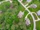An aerial view of the property and surrounding lush green trees and neighborhood at 3104 Whitehart Ln, Apex, NC 27539