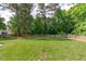 Large, fenced-in backyard with a spacious lawn and mature trees at 3104 Whitehart Ln, Apex, NC 27539