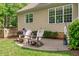 Cozy backyard patio with two chairs, grill, and views of the lush green lawn and landscaped garden at 3104 Whitehart Ln, Apex, NC 27539