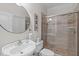 Well-lit bathroom featuring a stand-up shower, a round mirror over the sink, and tiled floors at 3104 Whitehart Ln, Apex, NC 27539