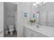 Bright bathroom showcasing a large mirror, fresh white vanity, and framed art at 3104 Whitehart Ln, Apex, NC 27539