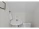 Neutral-toned half bath featuring a pedestal sink and toilet at 3104 Whitehart Ln, Apex, NC 27539