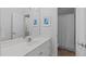 Clean, white bathroom with a single vanity, a large mirror, and a shower with a curtain at 3104 Whitehart Ln, Apex, NC 27539