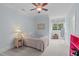 Cozy, light blue bedroom with a twin bed, large window, and neutral carpeting at 3104 Whitehart Ln, Apex, NC 27539