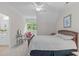 Bright bedroom featuring a ceiling fan, a seating area, and a window with a lovely view of the outdoors at 3104 Whitehart Ln, Apex, NC 27539