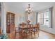 Traditional dining room with wood table, chairs, chandelier, and built-in china cabinet at 3104 Whitehart Ln, Apex, NC 27539