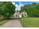 Beautiful home with a manicured lawn, trees, and paved driveway at 3104 Whitehart Ln, Apex, NC 27539