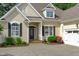 Charming home with black shutters, inviting front entrance, and manicured landscaping at 3104 Whitehart Ln, Apex, NC 27539