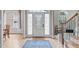 Bright foyer featuring hardwood floors, a staircase, and a door with glass panels at 3104 Whitehart Ln, Apex, NC 27539