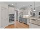 Well-lit kitchen with stainless steel appliances, granite countertops, and white cabinetry at 3104 Whitehart Ln, Apex, NC 27539