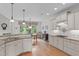 Bright kitchen with bar seating, white cabinets, and views into the dining area at 3104 Whitehart Ln, Apex, NC 27539