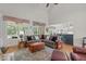 Bright living room with large sectional sofa, wood floors, and natural light at 3104 Whitehart Ln, Apex, NC 27539