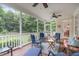 Relaxing screened-in porch with ceiling fan, blue chairs, and views of the lush backyard at 3104 Whitehart Ln, Apex, NC 27539