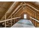 Unfinished attic space with exposed wooden beams and one window at 32 Iroquois Ct, Garner, NC 27529