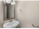Stylish powder room featuring a decorative mirror and a pedestal sink at 32 Iroquois Ct, Garner, NC 27529