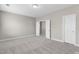 A bright bedroom with neutral carpet and two doorways at 32 Iroquois Ct, Garner, NC 27529