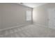 A cozy bedroom featuring neutral carpet, trim and a bright window at 32 Iroquois Ct, Garner, NC 27529