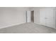 A bright bedroom with neutral carpet and a closet at 32 Iroquois Ct, Garner, NC 27529
