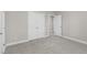 A bright bedroom with neutral carpet, a closet and an open door at 32 Iroquois Ct, Garner, NC 27529