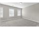 A bright bedroom with neutral carpet and two bright windows at 32 Iroquois Ct, Garner, NC 27529