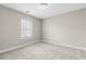 A bright bedroom with neutral carpet and a bright window at 32 Iroquois Ct, Garner, NC 27529
