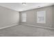 A bright bedroom with neutral carpet and two bright windows at 32 Iroquois Ct, Garner, NC 27529