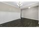 An open dining room with dark wood floors and an elegant chandelier at 32 Iroquois Ct, Garner, NC 27529
