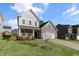 Charming two-story home with gray siding, brick accents, and a well-manicured lawn at 32 Iroquois Ct, Garner, NC 27529