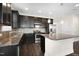 Modern kitchen with stainless steel appliances, granite countertops, and dark cabinetry at 32 Iroquois Ct, Garner, NC 27529