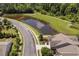 Aerial view of home near a pond with walking path, showcasing community amenities and neighborhood layout at 323 Rosedale Creek Dr, Durham, NC 27703