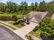 Stunning aerial view of a well-maintained home with lush landscaping and a serene pond backdrop at 323 Rosedale Creek Dr, Durham, NC 27703