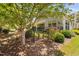 Lush backyard with a wrought iron fence, plants, and a view of the covered patio at 323 Rosedale Creek Dr, Durham, NC 27703