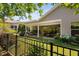 Covered patio with seating and dining areas overlooking a well-manicured lawn and garden at 323 Rosedale Creek Dr, Durham, NC 27703
