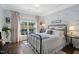 Cozy bedroom with floral wallpaper, a ceiling fan, and large windows that offer plenty of natural light at 323 Rosedale Creek Dr, Durham, NC 27703