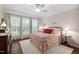 Charming bedroom with a plush rug, neutral walls, and natural light streaming through large windows at 323 Rosedale Creek Dr, Durham, NC 27703