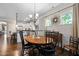 Bright dining area with wood floors, white trim, and windows offering natural light at 323 Rosedale Creek Dr, Durham, NC 27703