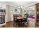 Traditional dining room featuring hardwood floors, neutral walls, and a round dining table with black chairs at 323 Rosedale Creek Dr, Durham, NC 27703