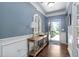 Inviting entryway with hardwood floors, wainscoting, and a charming console table with decor at 323 Rosedale Creek Dr, Durham, NC 27703