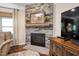 Stone fireplace with mantel and hearth, perfect for a cozy evening, with a television to the right at 323 Rosedale Creek Dr, Durham, NC 27703