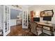 Home office featuring a wooden desk with an executive chair, ornate decorations, and french doors at 323 Rosedale Creek Dr, Durham, NC 27703