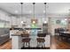 Modern kitchen with stainless steel appliances, granite countertops, and a central island with seating at 323 Rosedale Creek Dr, Durham, NC 27703