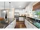 Stylish kitchen featuring white cabinets, granite countertops, and stainless steel appliances at 323 Rosedale Creek Dr, Durham, NC 27703